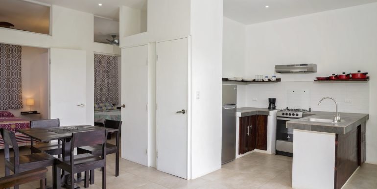 Multiunit Apartment Building in Town - San Juan del Sur - Invest Nicaragua - 2_Bedroom_Apartment_Top_Floor_Left_Side_Kitchen_Partial_Dining_CC
